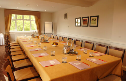 boardroom, flipchart, meeting room, notepad and pencil, fruits in bowls, water bottles