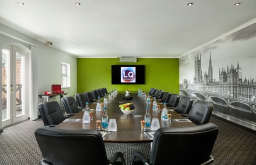 boardroom, black comfortable chairs, green featured wall, natural daylight