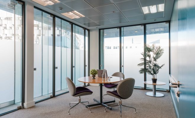 modern event space, meeting room, small round table, three comfortable office chairs, plants