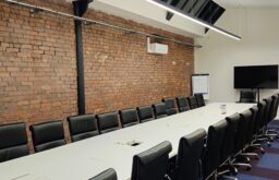 large meeting room, boardroom, TV screen, flipchart