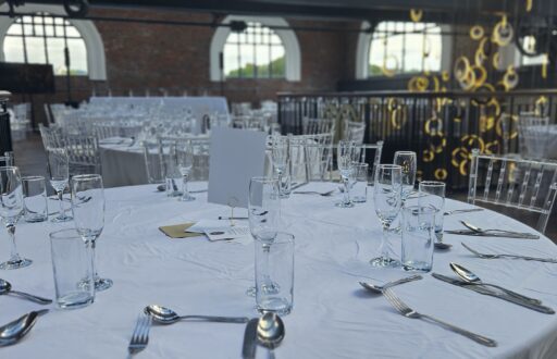 dinner set up, cabaret layout, water and wine glasses, cutlery