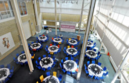 conference setting, cabaret layout, water bottles on tables, projector screen