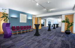 exhibition space, standing tables, chairs lining the wall