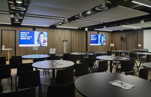two large plasmas screen, cabaret conference layout, lecturn, stage