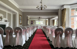 rows of seat, runway in between the rows, a long event space