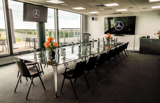 modern meeting room, natural lighting, lecturn, TV screens, large boardroom layout