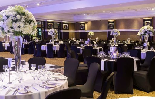 cabaret layout, fine dining, black chairs, event space