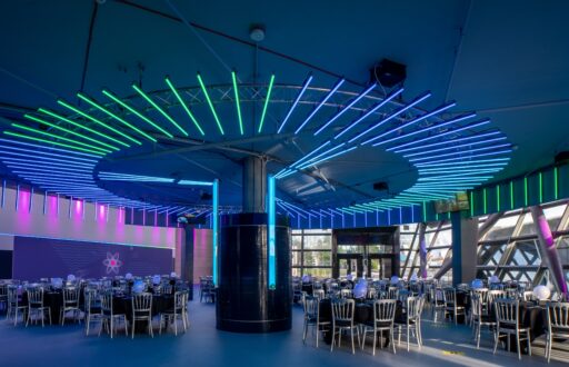conference room, colourful lighting, cabaret layout, large event space