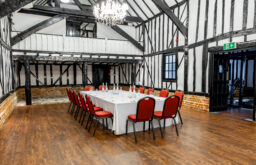 meeting room, boardroom setup, water bottles, notepads, barn event space