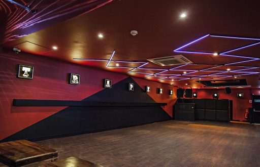 basement event space, red walls, ceiling lights