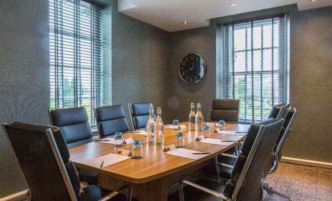 small meeting space, comfortable black chairs, windows