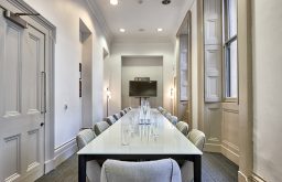plasma screen, modern comfortable chairs, water bottles, meeting room