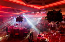 red lit up room, flowers in the stand, gala dinner