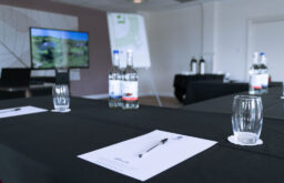 flipchart, water bottles, water glasses, note paper, TV screen