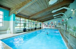 swimming pool, painting on the wall, wood panelling on the celing