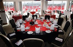 dinner set up, red and black table cloths, event