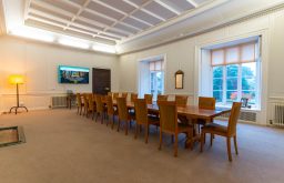 large meeting room, boardroom layout, laptop