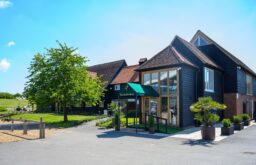 entrance to theevent space, exterior of The Heron Country Club , bright blue sky