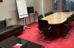 flip chart, boardroom, sofa seating area, red plush carpet