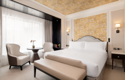 luxury hotel suite, 5* accomodation, armchairs and a table at the side of the bed