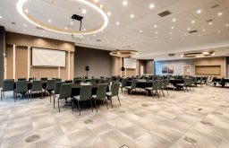 modern space, two projector screens, cabaret layout, large conference space