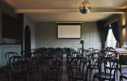 conference room, theatre layout, lecturn, coffee and water at the side on the table