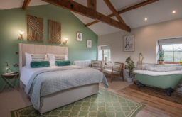 nicley decorated farm suite, bath beside the be, two chairs in the corner