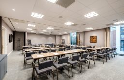 classroom setup, rows of tables, conference room, flipchart