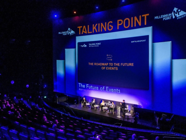 darkly lit, lecturn, blue and purple colours, auditorium in a Birmingham venue