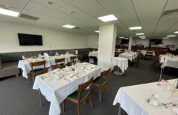 dining, tables, number seating, bar area to the side of the room, TV screen