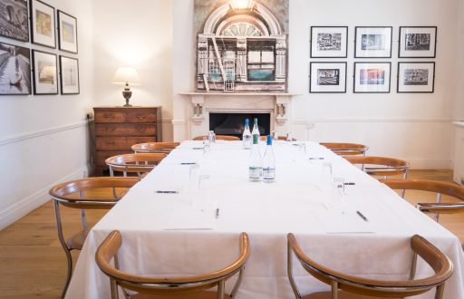 boardroom layout, wooden chairs, bright, framed photographs