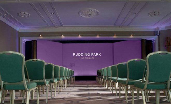 conference space, massive projector screen, green chairs