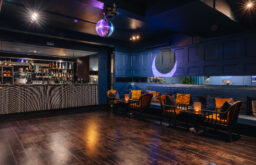 bar, disco ball, event space, dancing area, chairs and tables of the corner