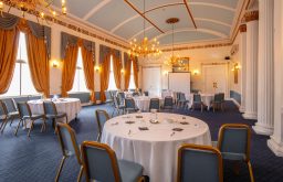 cabaret layout, projector screen, historic & modern conference room