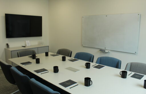 boardroom, TV screen, whiteboard, notepads, mugs, meeting room
