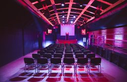 red lighting, theatre layout, stage, projector screen